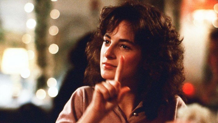 Marlee Matlin levantando un dedo en una escena de Children of a Lesser God.