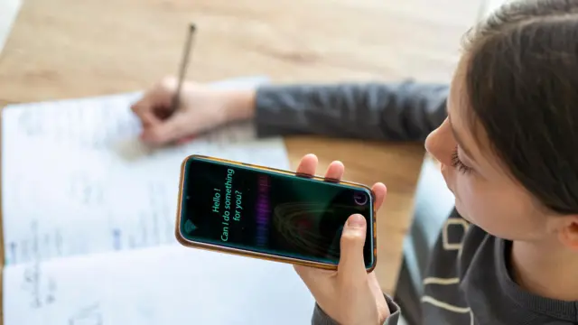Una niña usa un asistente virtual de IA para hacer las tareas escolares. 