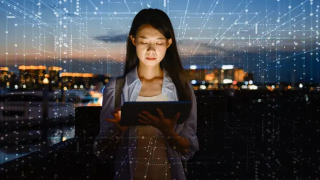 Una mujer con una tableta usando inteligencia artificial