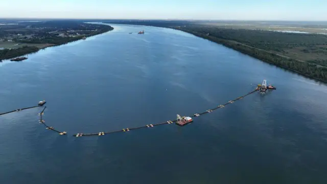 Vista aérea, tuberías atravesando el río Misisipi mientras el Cuerpo de Ingenieros del Ejército de los EE. UU. traslada sedimentos a un umbral submarino en el fondo del río Misisipi para ayudar a frenar el flujo de una intrusión de agua salada